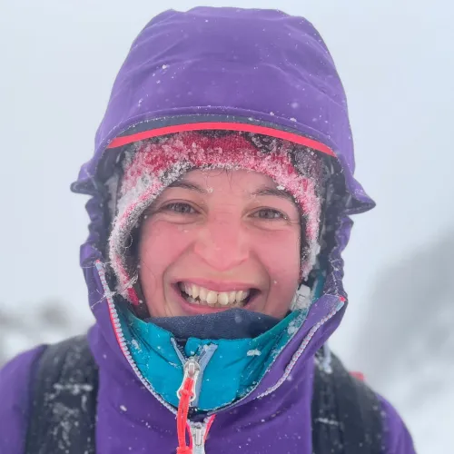 Kirsty Pallas, 30 under 30 nominee in 2023 smiling at the camera covered in snow.